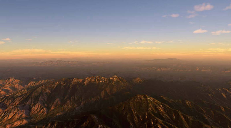 Scenic aerial view of mountains bathed in the warm glow of sunset.
