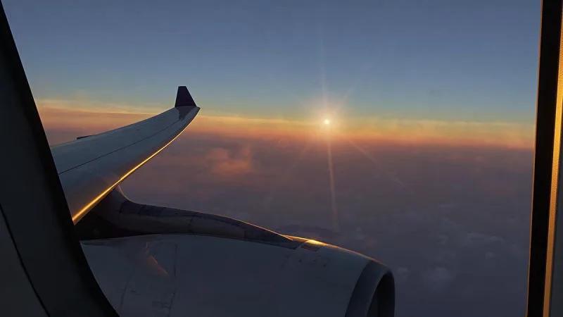 Sunset over the clouds seen past the wing and engine from the cabin, REX Atmos CORE in Microsoft Flight Simulator 2024