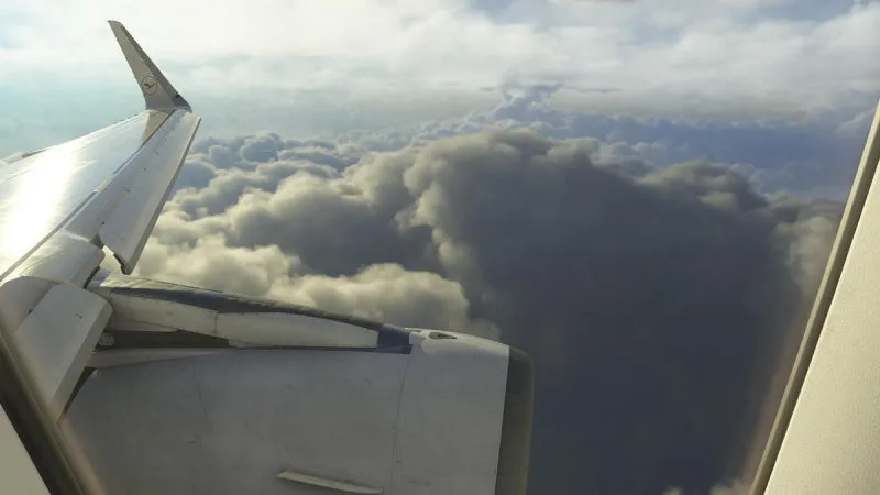 Cabin view over the wing and engine above dramatic cloud tops, REX Atmos CORE volumetric clouds in Microsoft Flight Simulator 2024